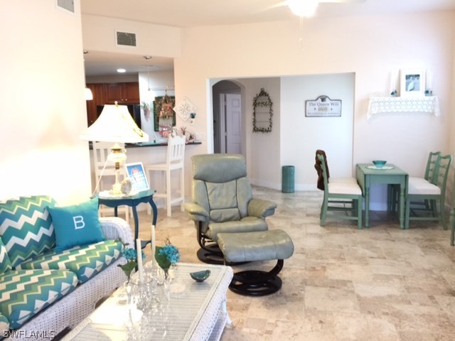 17210 Acapulco Road, Unit 211 Punta Gorda, FL 33955 - Photo 4 of 23 a living room with furniture and a chandelier