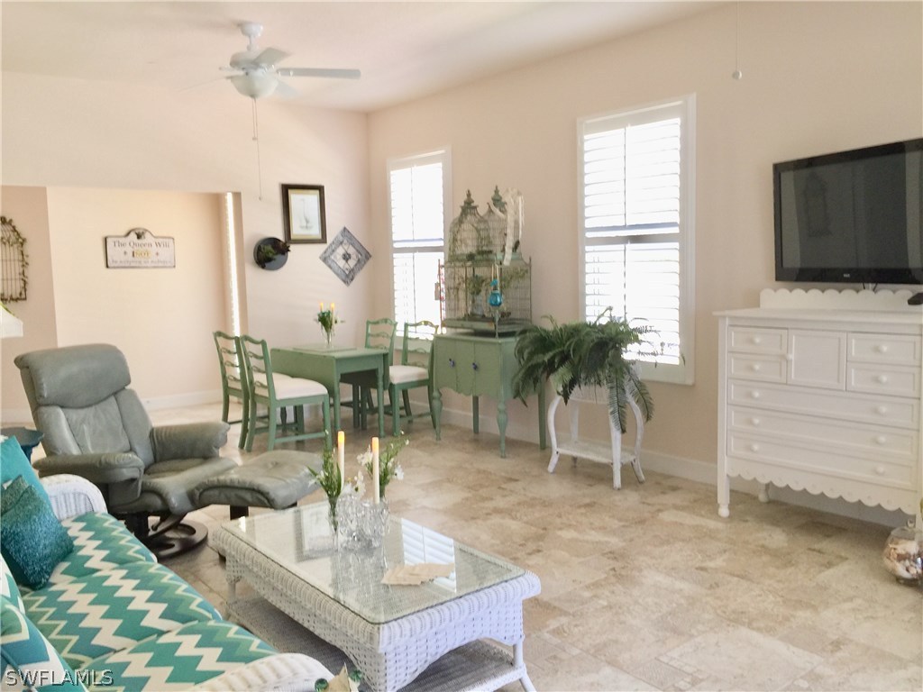 17210 Acapulco Road, Unit 211 Punta Gorda, FL 33955 - Photo 5 of 23 a living room with furniture a flat screen tv and a window