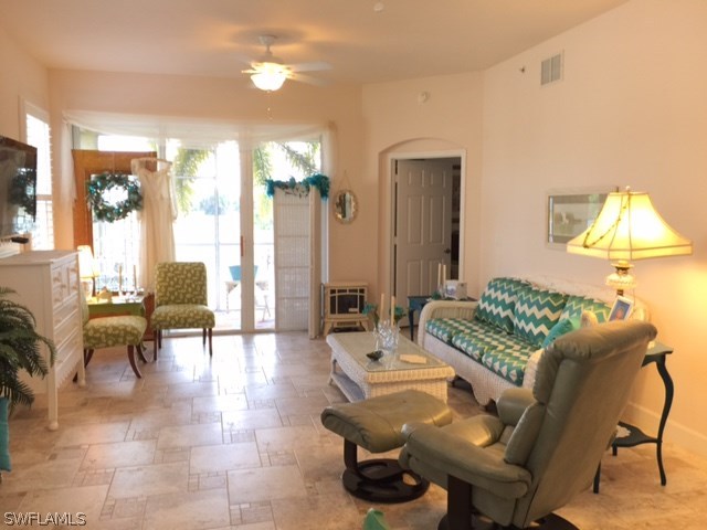 17210 Acapulco Road, Unit 211 Punta Gorda, FL 33955 - Photo 6 of 23 a living room with furniture and a lamp