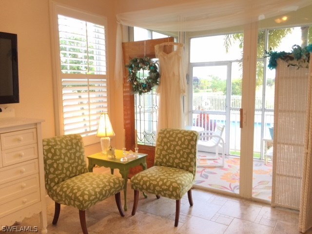 17210 Acapulco Road, Unit 211 Punta Gorda, FL 33955 - Photo 7 of 23 a living room with furniture and a floor to ceiling window