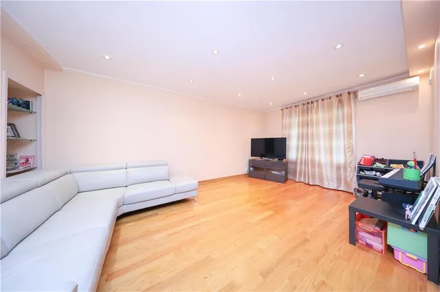 a bedroom with furniture and a flat screen tv