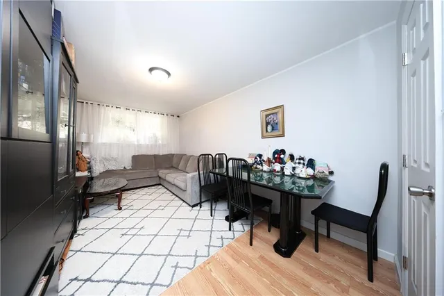 a living room with furniture and a painting on the wall