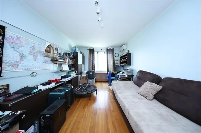 a living room with furniture fireplace and a window