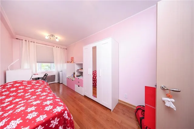 a bedroom with furniture and a wooden floor