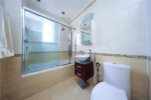 a bathroom with a sink a toilet and bathtub