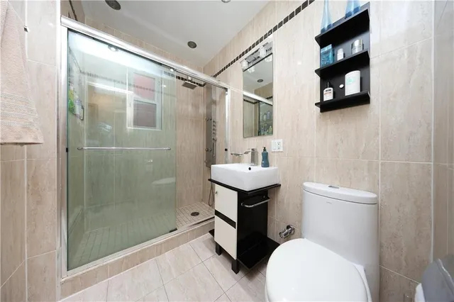 a bathroom with a toilet sink and shower