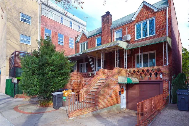 a front view of a building with outdoor seating