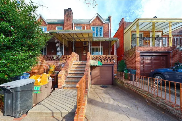 a view of a brick house with large windows