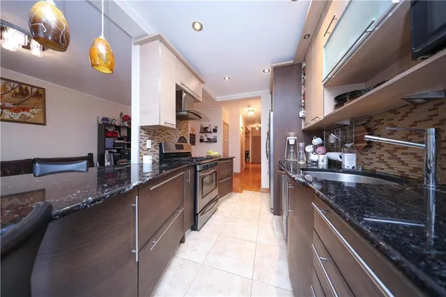 a large kitchen with stainless steel appliances granite countertop lots of counter top space