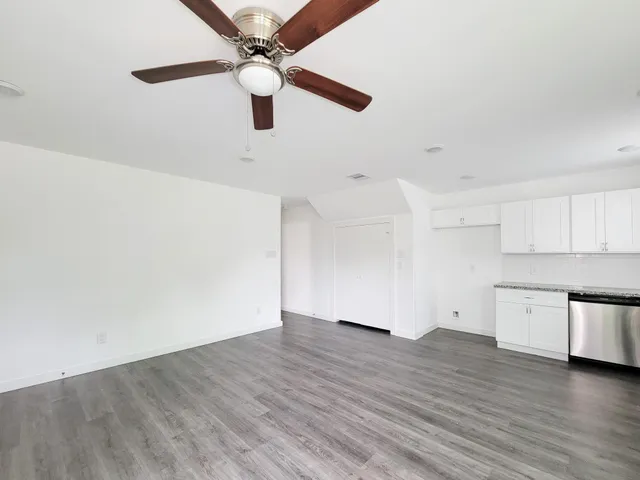 a view of a kitchen with a dishwasher and wooden floor