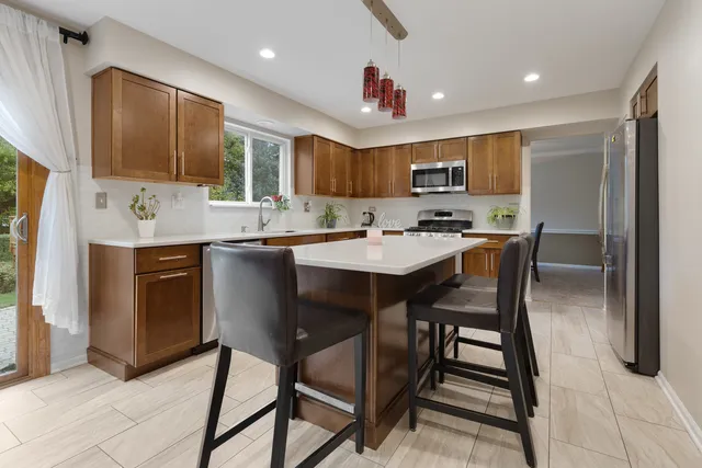a kitchen with granite countertop a sink counter space and cabinets