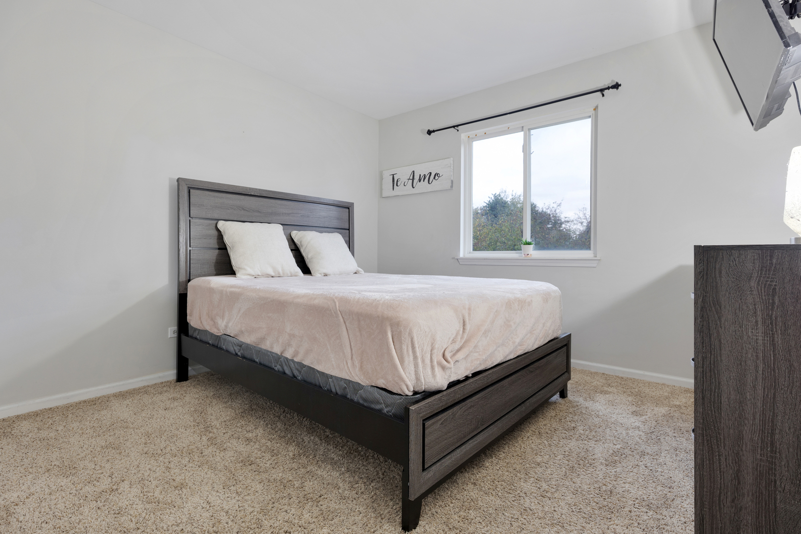 611 Woodbridge Drive Elgin, IL 60124 - Photo 21 of 28 a large bed sitting in a bedroom next to a window