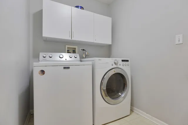 an aerial view of a house with swimming pool and large trees