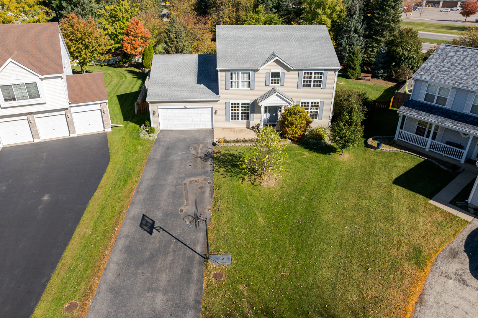 611 Woodbridge Drive Elgin, IL 60124 - Photo 28 of 28 an aerial view of a house with swimming pool and large trees