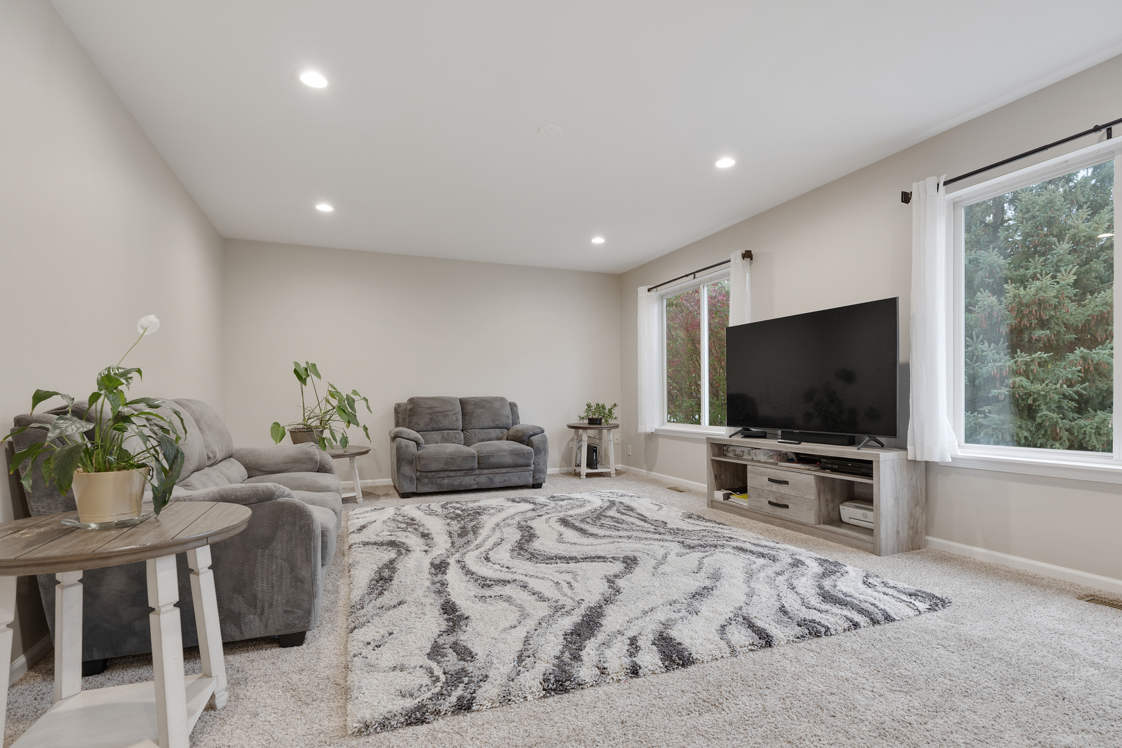 611 Woodbridge Drive Elgin, IL 60124 - Photo 6 of 28 a living room with furniture and a flat screen tv