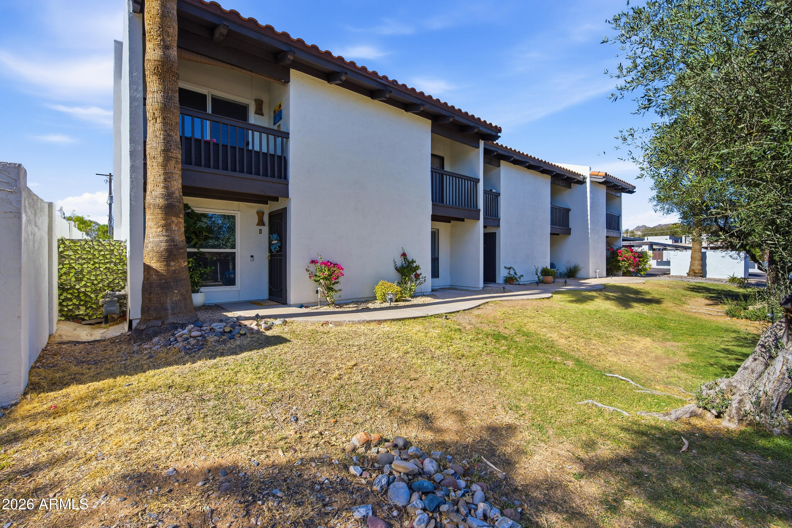 1702 East Ocotillo Road, Unit 1 Phoenix, AZ 85016 - Photo 2 of 27 a swimming pool with outdoor seating and yard