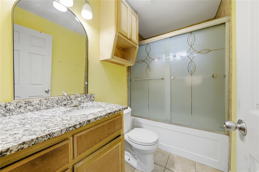 3624 Redbird Street Bellmead, TX 76705 - Photo 17 of 20 a bathroom with a granite countertop sink toilet and shower
