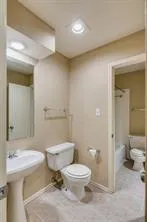a bathroom with a toilet a sink and shower