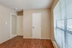 a view of hallway with wooden floor