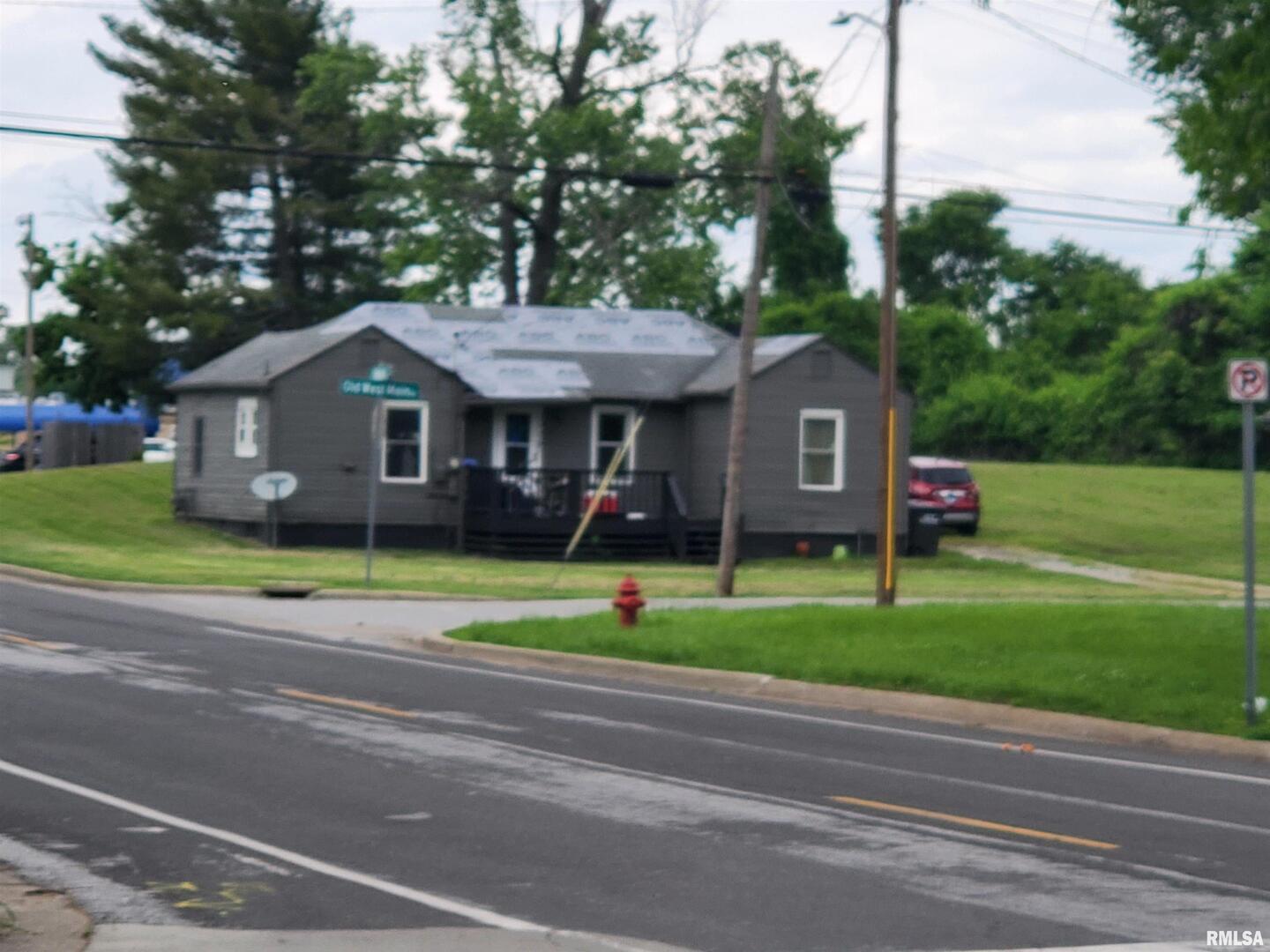 a front view of a house with a yard table and chairs