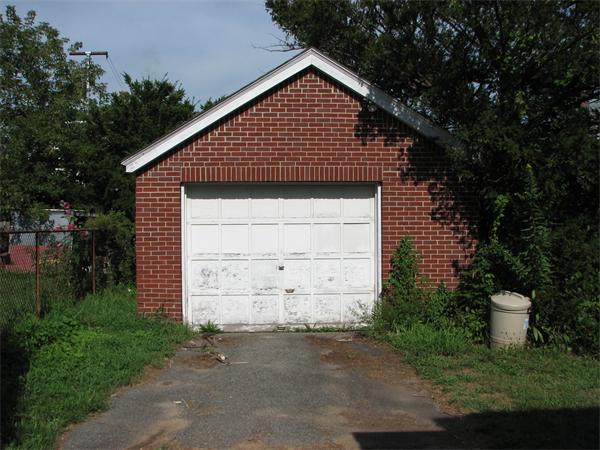 68 Montgomery Street Springfield, MA 01151 - Photo 6 of 15 a front view of a house with a yard and garage