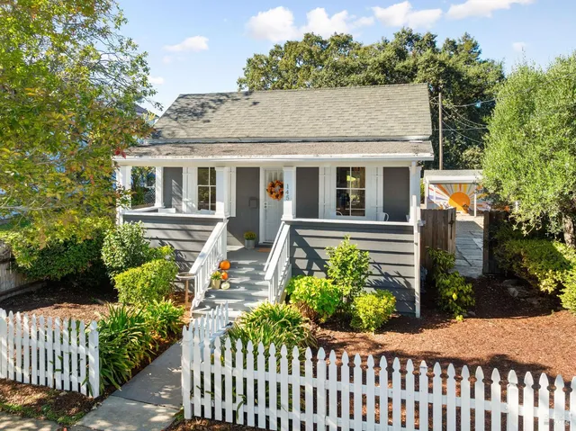 a view of a house with wooden fence