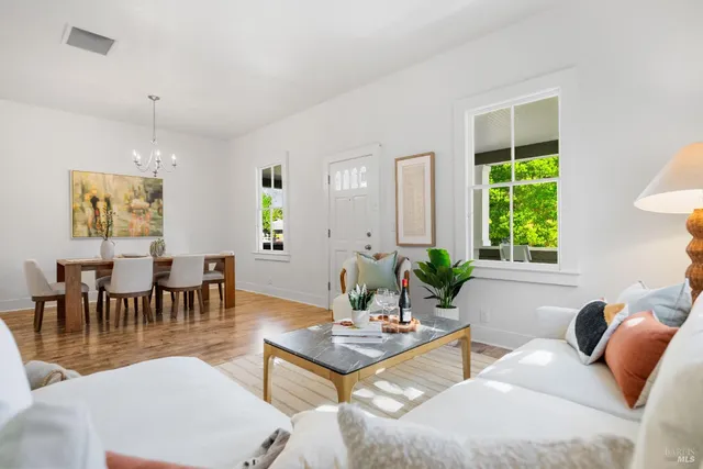 a bed room with a bed and a chair with the view of bathroom