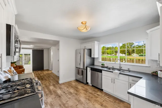 a bathroom with a sink a light fixture and a mirror