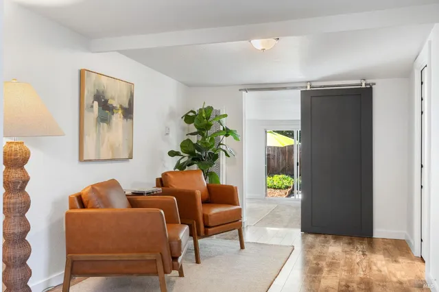 a view of a patio with a table and chairs and potted plants