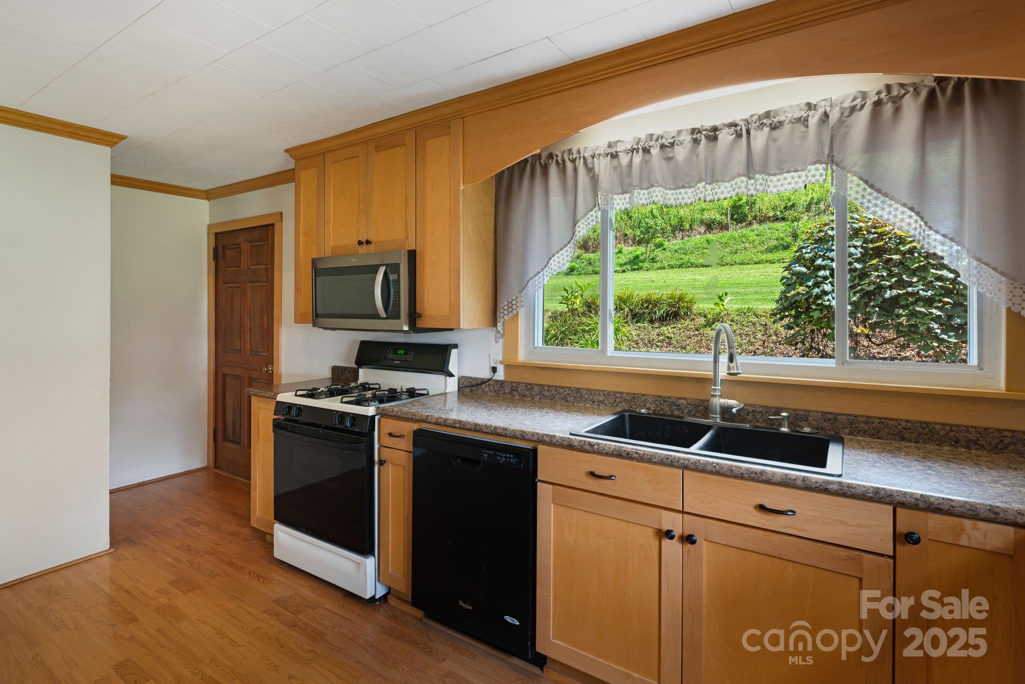 474 Smith Creek Road Mars Hill, NC 28754 - Photo 14 of 27 a kitchen with granite countertop a sink and a stove