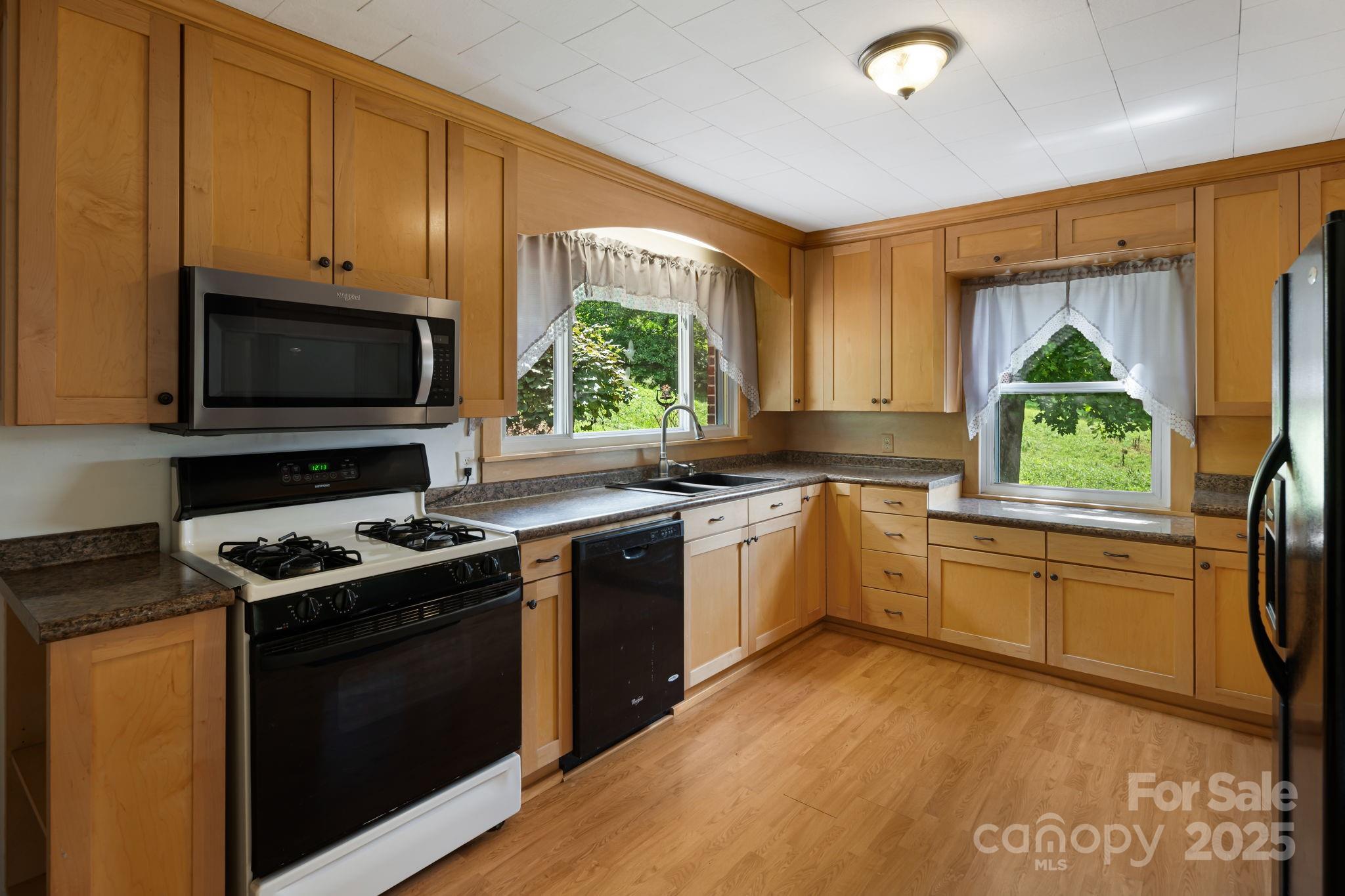 474 Smith Creek Road Mars Hill, NC 28754 - Photo 15 of 27 a kitchen with a stove a sink and a microwave