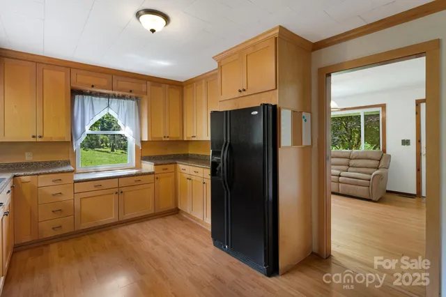 a kitchen with granite countertop a refrigerator and a sink