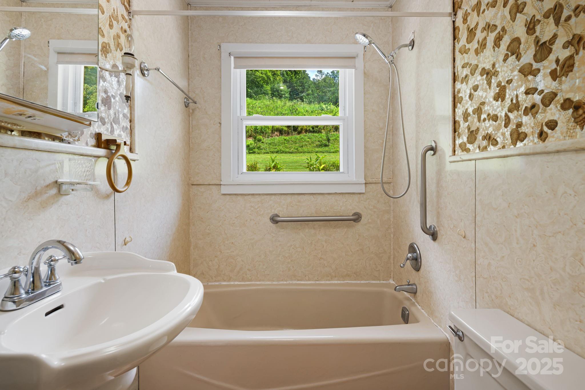 474 Smith Creek Road Mars Hill, NC 28754 - Photo 17 of 27 a bathroom with a sink a window and a shower