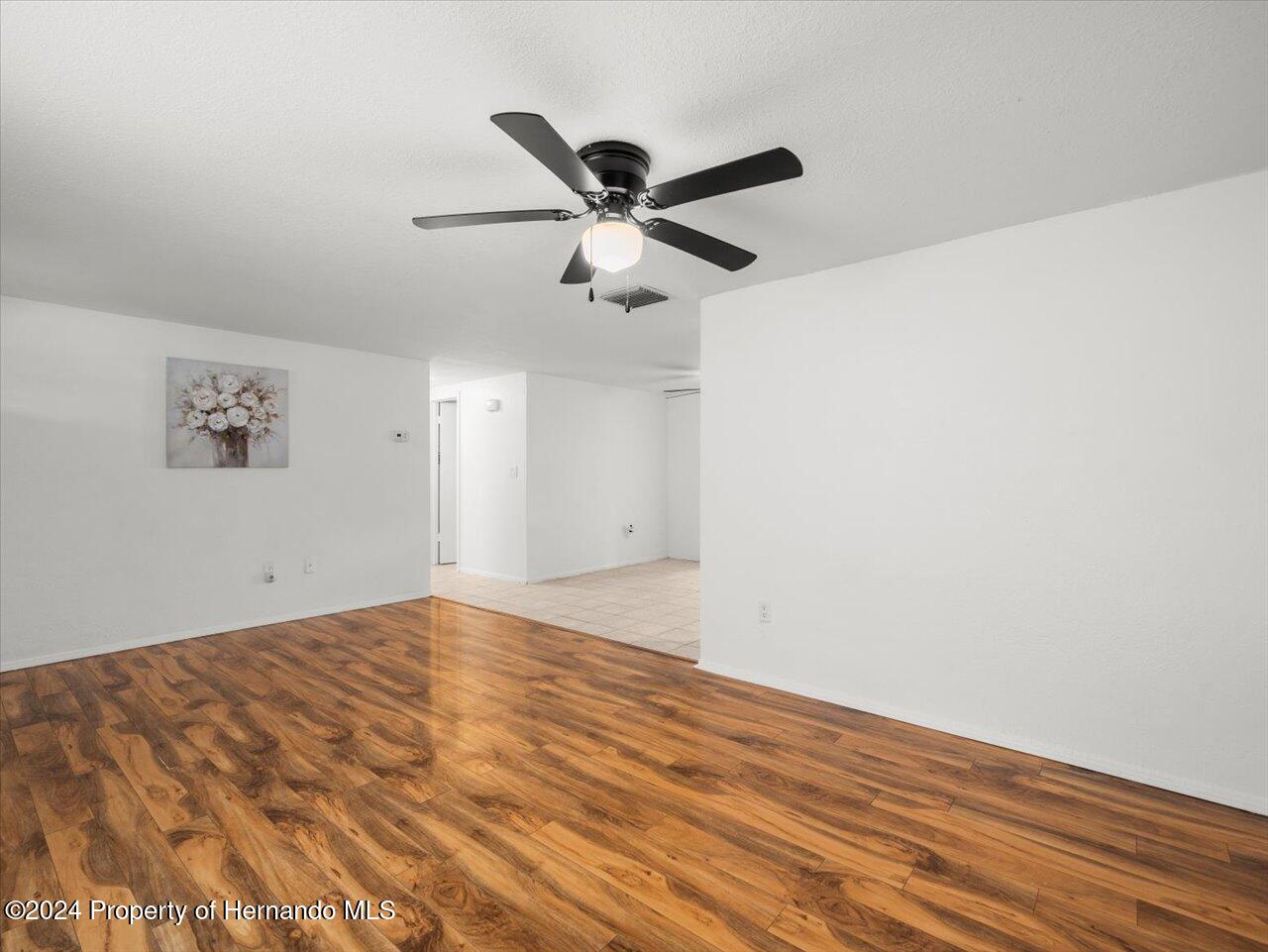 3902 Glissade Drive New Port Richey, FL 34652 - Photo 12 of 39 a view of empty room with wooden floor