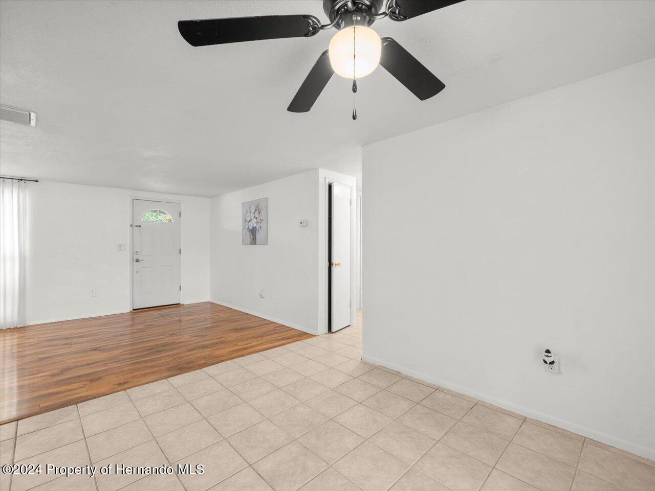 3902 Glissade Drive New Port Richey, FL 34652 - Photo 15 of 39 an empty room with ceiling fan and window