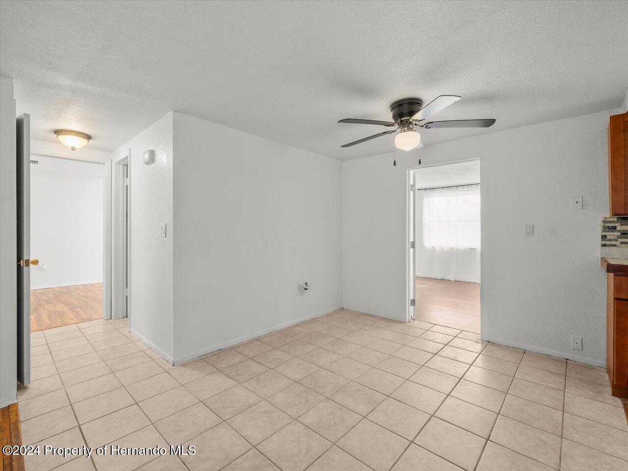 3902 Glissade Drive New Port Richey, FL 34652 - Photo 16 of 39 a view of an empty room and chandelier fan