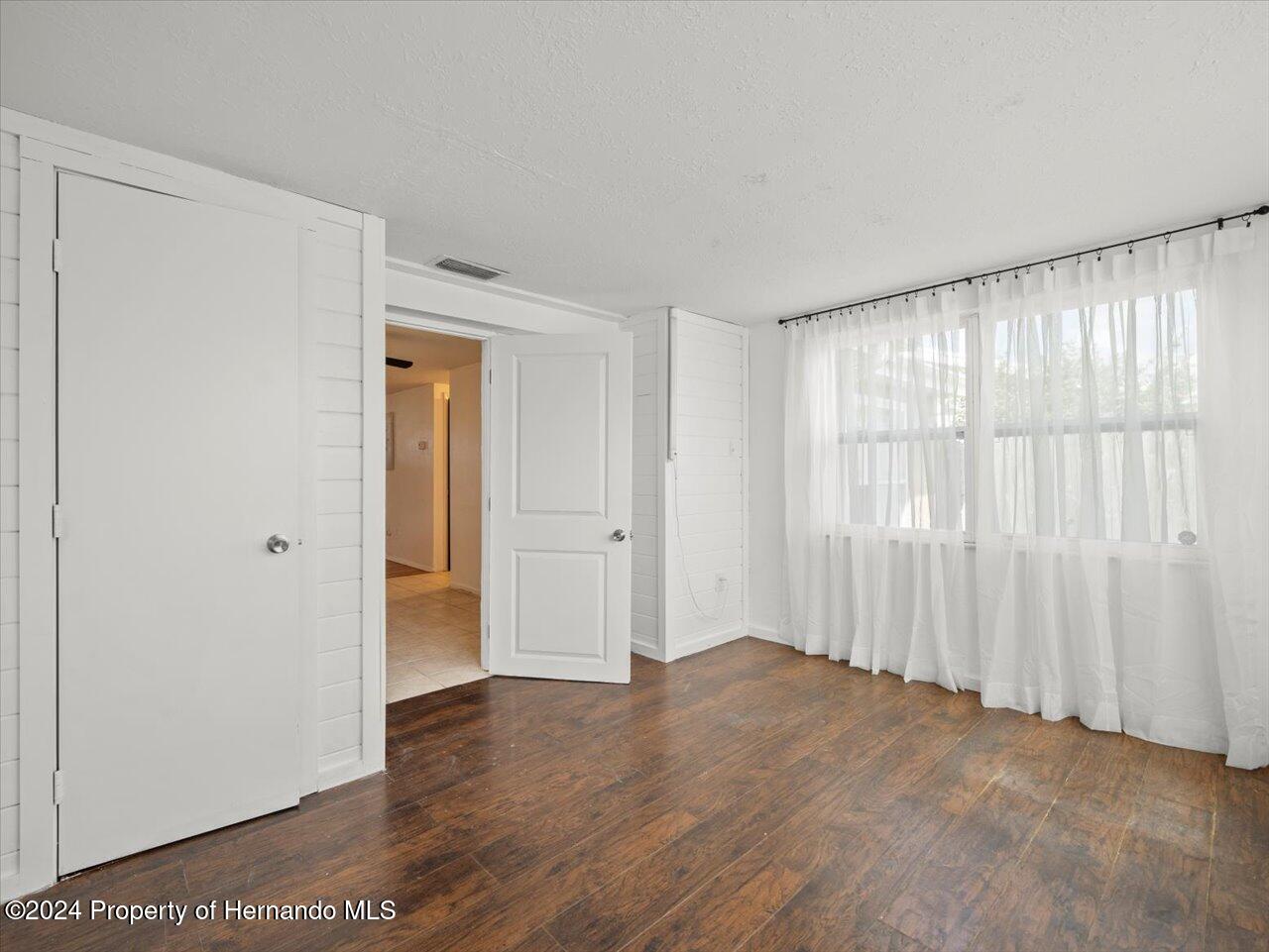 3902 Glissade Drive New Port Richey, FL 34652 - Photo 26 of 39 a view of entryway with wooden floor