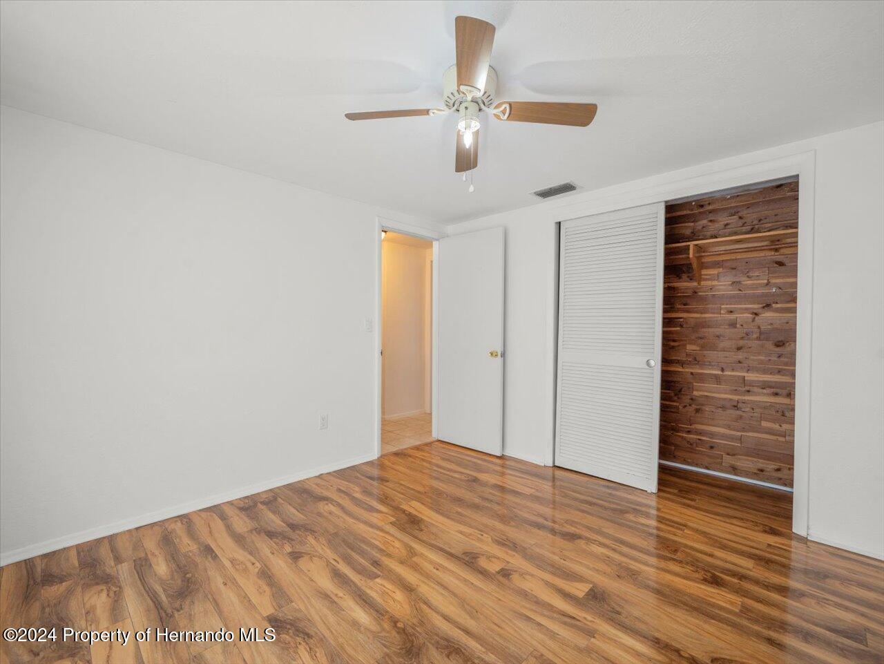 3902 Glissade Drive New Port Richey, FL 34652 - Photo 29 of 39 a view of empty room with wooden floor