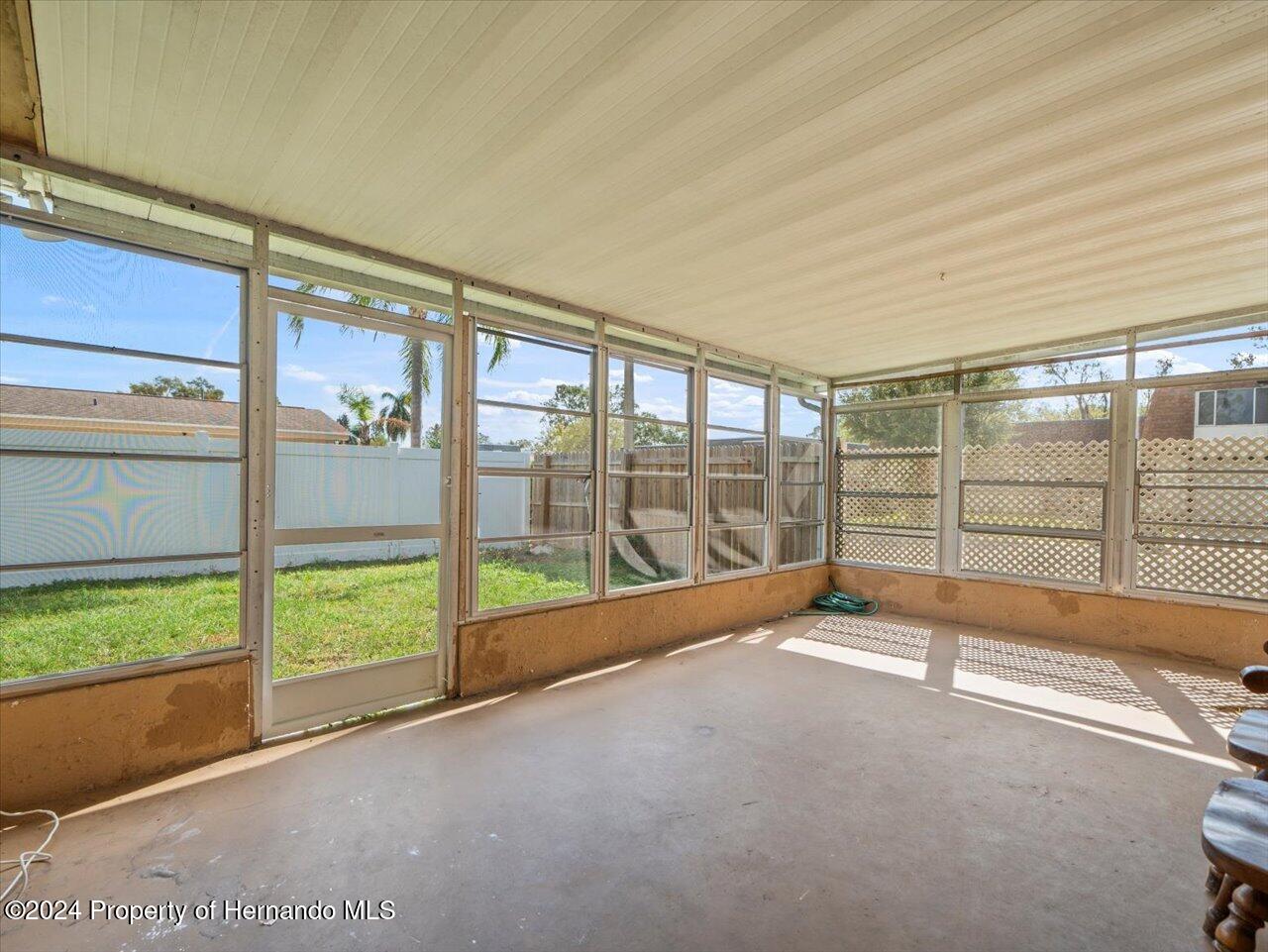 3902 Glissade Drive New Port Richey, FL 34652 - Photo 32 of 39 a view of an empty room with a sliding door