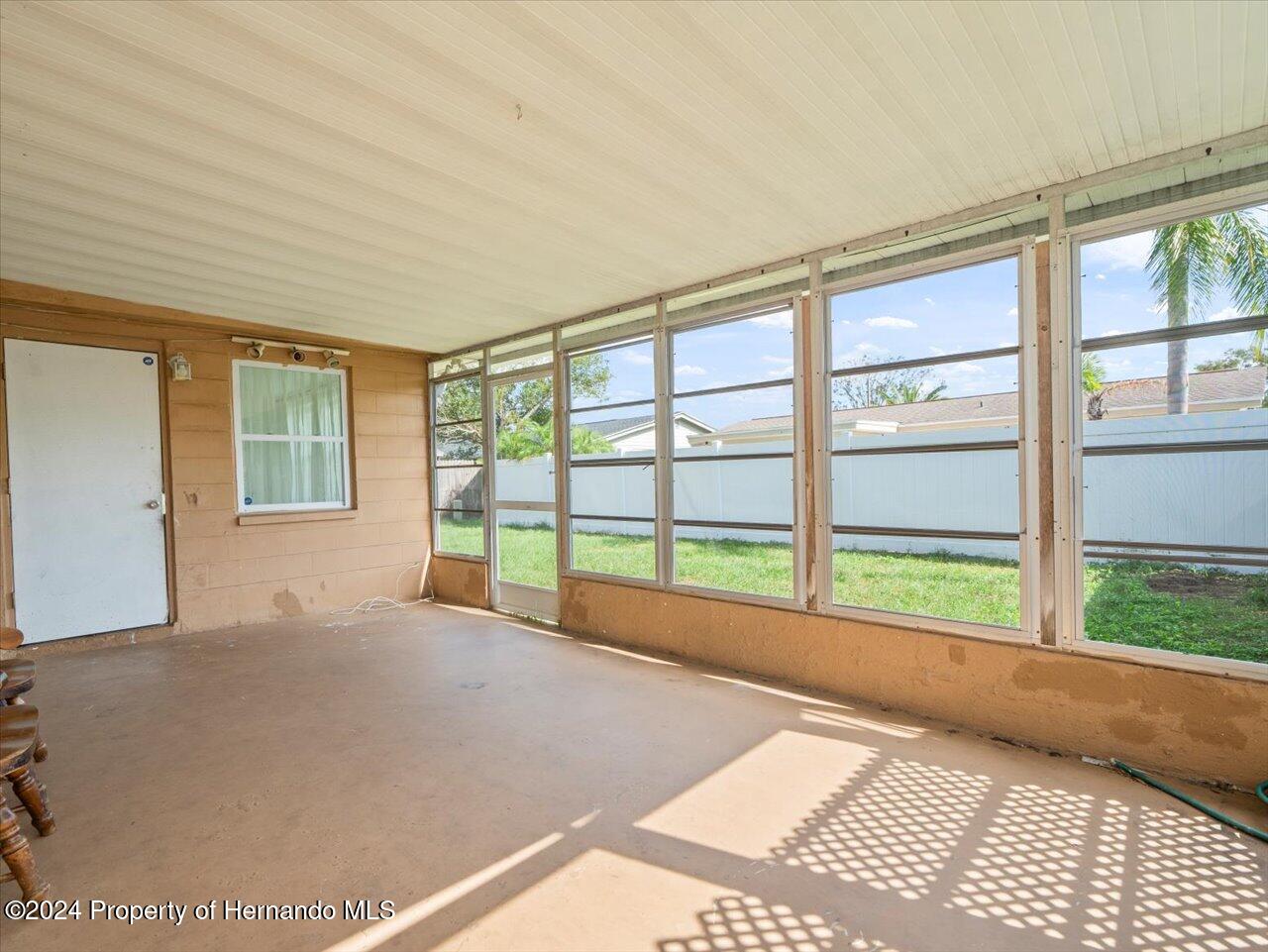 3902 Glissade Drive New Port Richey, FL 34652 - Photo 33 of 39 a view of a room with wooden floor and windows