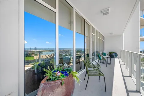 a very nice looking room with a large window and chairs