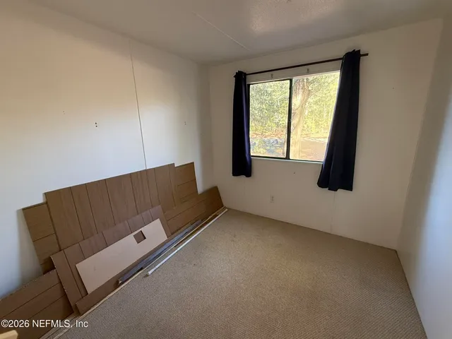 a room with a chair and white walls