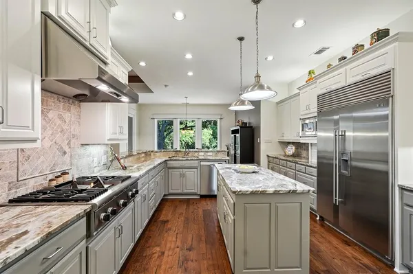 a kitchen with a sink stove and refrigerator