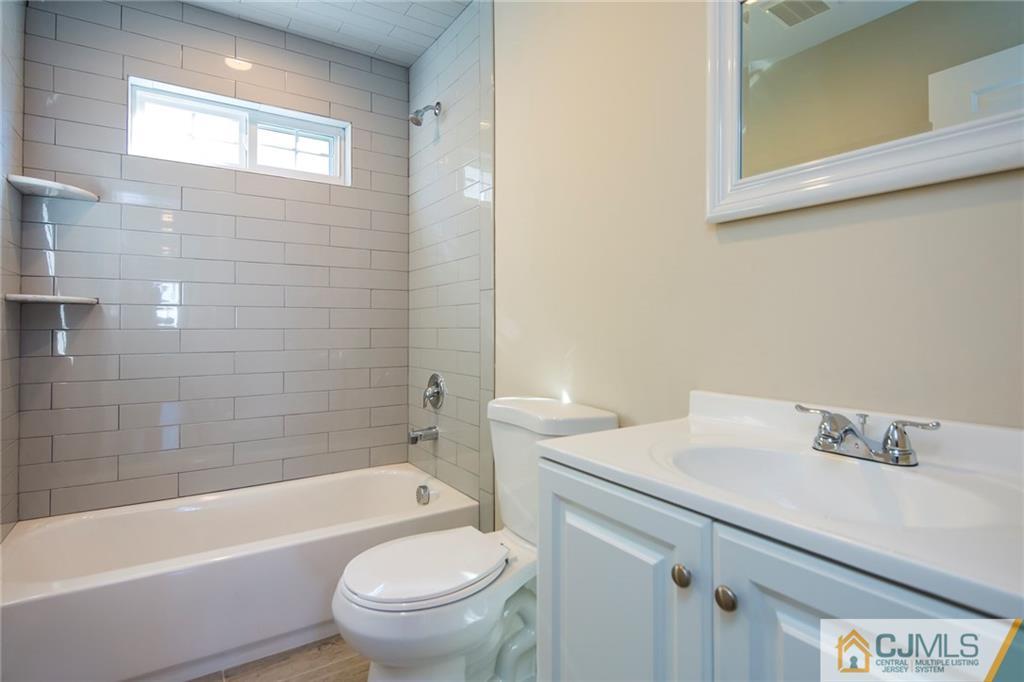 64 Idlewild Road Edison, NJ 08817 - Photo 22 of 22 a bathroom with a sink a toilet and bathtub