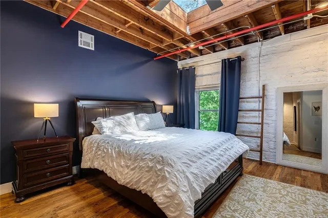 a bedroom with a bed and a mirror