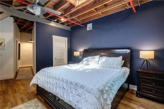 a bedroom with a bed and a lamp