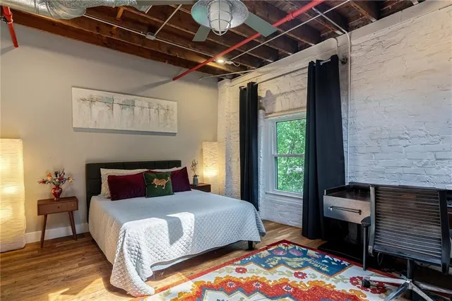 a bedroom with a bed next to a window with outer view