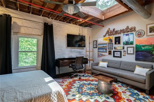 a living room with furniture a flat screen tv and a fireplace