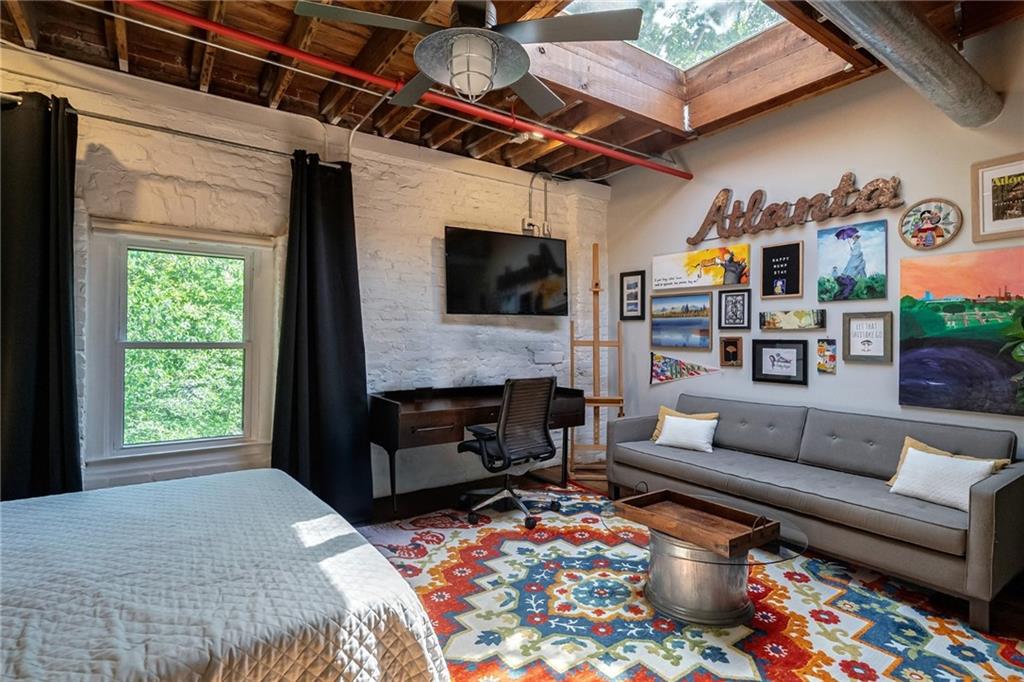 585 White Circle, Unit 402 Athens, GA 30605 - Photo 20 of 37 a living room with furniture a flat screen tv and a fireplace