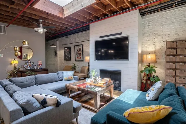 a living room with furniture a fireplace and a flat screen tv